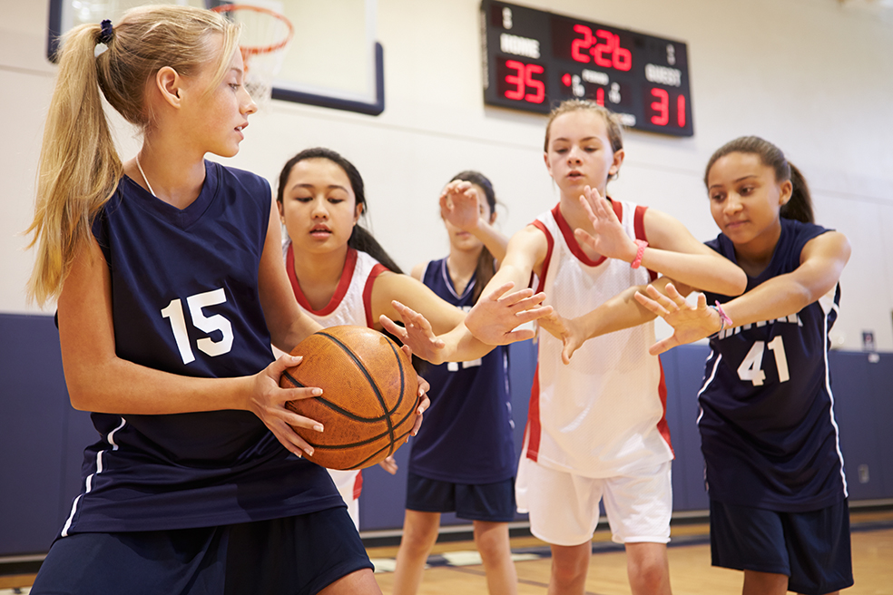 Female high school basketball player shooting basket